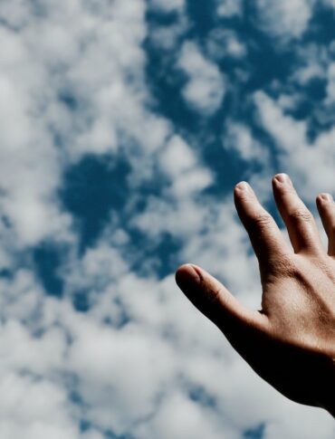 person hand reaching for the sky