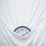round black clock on linen
