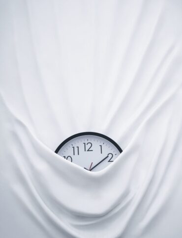 round black clock on linen