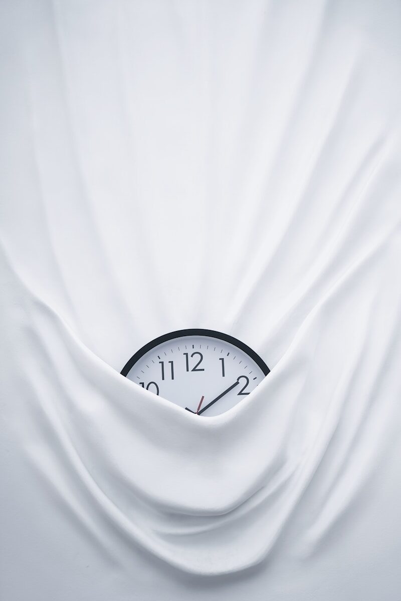 round black clock on linen